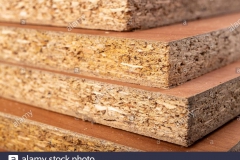particle-board-for-the-construction-of-home-furniture-material-stacked-in-the-carpentry-shop-light-background-2DAPN7P
